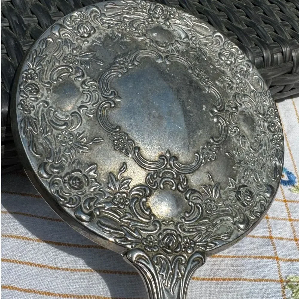 Vintage silver tone hand mirror embossed design on back so pretty